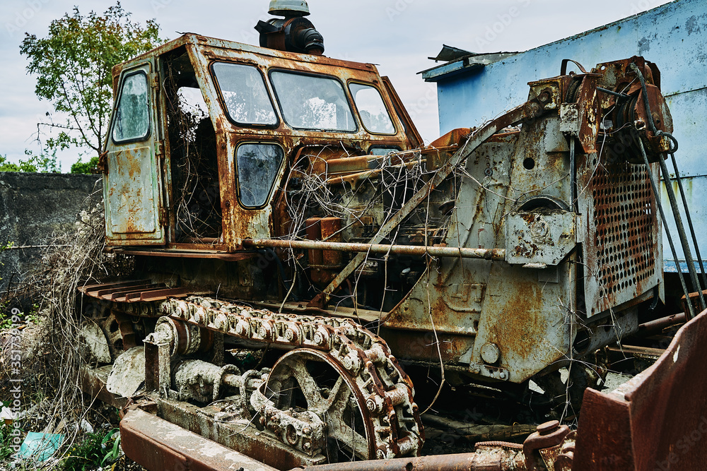 Old abandoned rusty broken tractor. Tractor in a landfill. Old abandoned rusty broken tractor. Tractor in a landfill.
