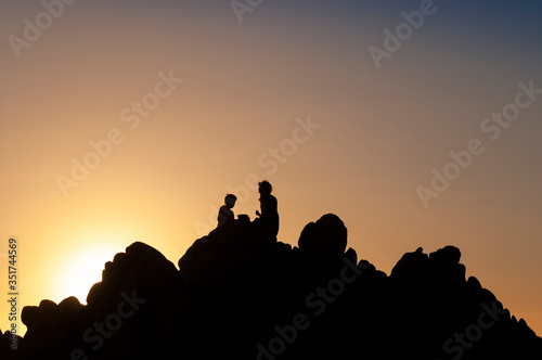 The family relaxes and enjoys nature on top of the rock. Chilean coastline