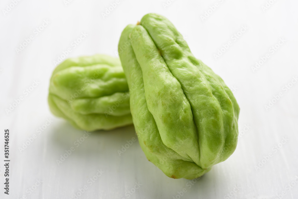Chayote squash or Mirlition squash on white table, Organic vegetable, Edible plant fruit Chayote squash or Mirlition squash on white table, Organic vegetable, Edible plant fruit