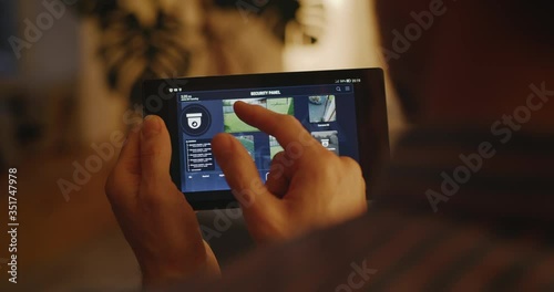 Man checking security camera through home hub