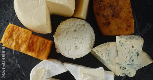 A set of different cheeses rotates slowly.