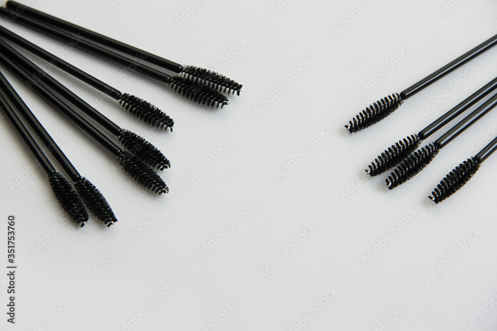 makeup artist set, lots of black mascara brushes on a white background close-up makeup artist set, lots of black mascara brushes on a white background close-up