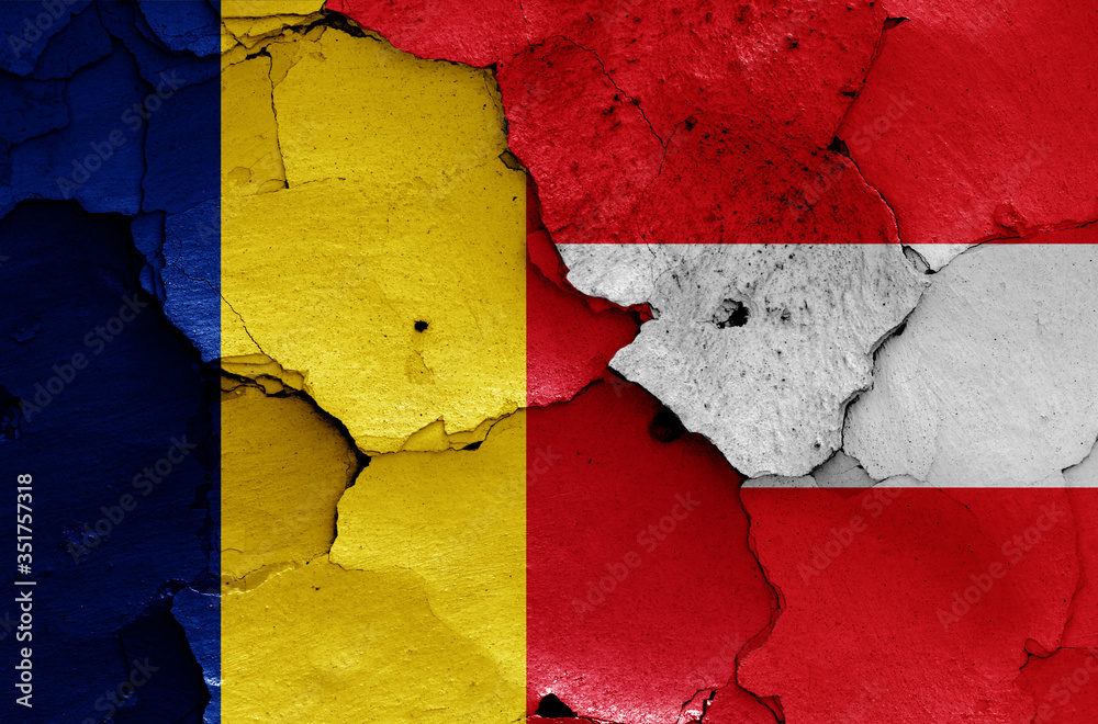 flags of Romania and Austria painted on cracked wall