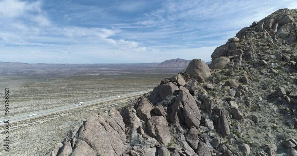 Flying over rocky outcrop on mountain reveals Interstate 10 in the USA Flying over rocky outcrop on mountain reveals Interstate 10 in the USA