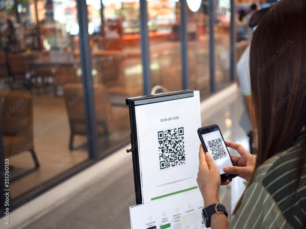people scan QR-code for check in on supermarket or tacking time line,  coronavirus or covid-19, new normal фотография Stock | Adobe Stock