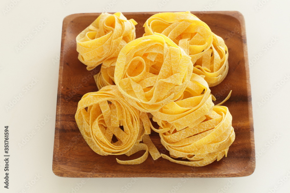 Italian food ingredient, flat noodles fettuccine Italian food ingredient, flat noodles fettuccine