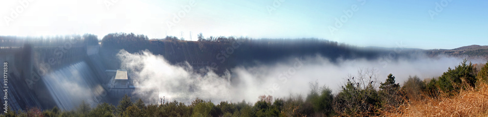 Bull Shoals dam in fog with the White river valley in the misty morning Sunlight. Bull Shoals dam in fog with the White river valley in the misty morning Sunlight.