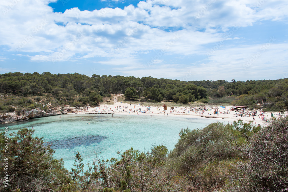 Beach with people and sea landscape in Santanyi, Majorca