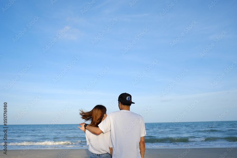 happy romantic wedding couple in love and look at the horizon with sunset