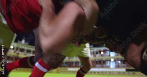 Male rugby players playing rugby in the stadium photo