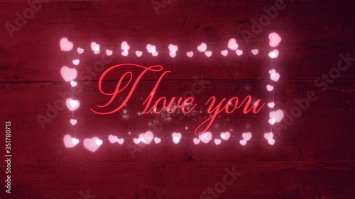 Animation of the words I love you written with sparkles surrounded by a frame of pink hearts photo