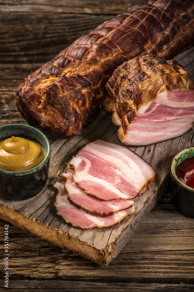 Slices of bacon on a wooden background. Brisket. top view Food recipe background. Close up