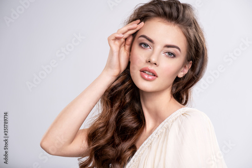 Fotografie Portrait of a young beautiful woman with a long hair.