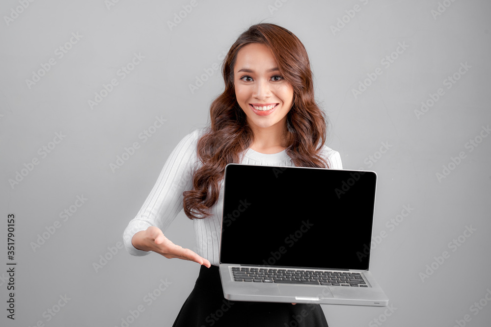 Businesswoman Presenting Laptop. Isolated On gray Background Businesswoman Presenting Laptop. Isolated On gray Background