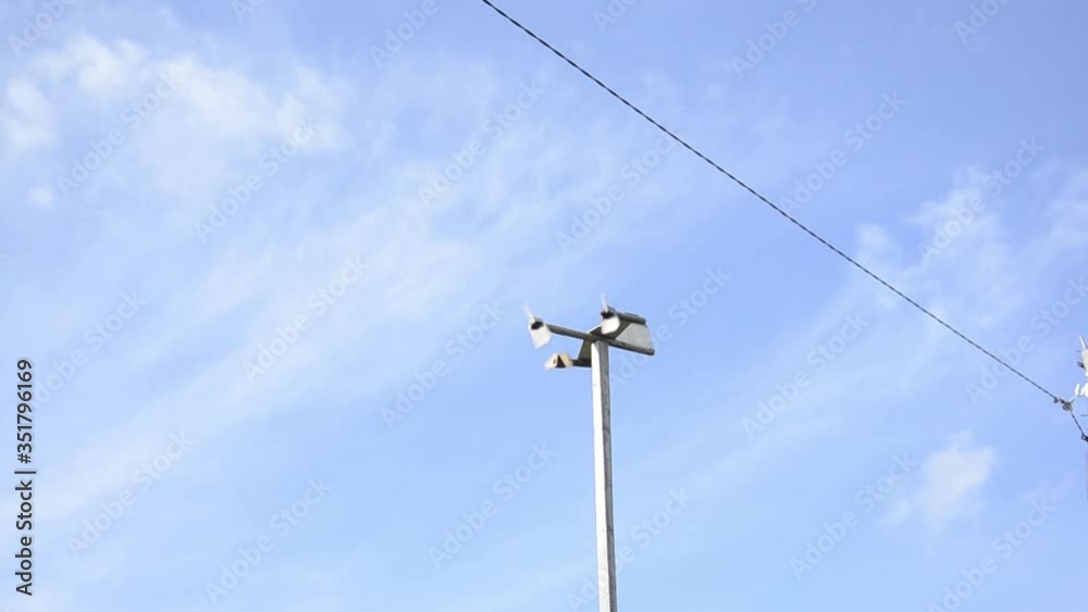 Homemade wooden weather vane against the blue sky Homemade wooden weather vane against the blue sky