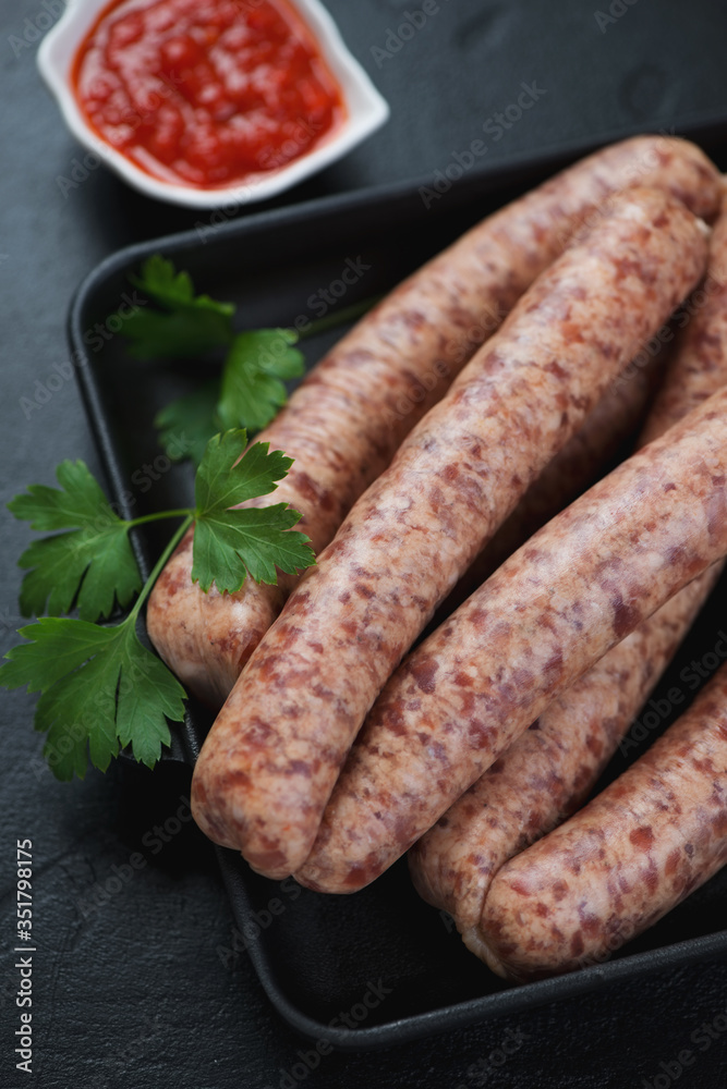 Close-up of raw sausages made of pork meat and poultry, selective focus, vertical shot Close-up of raw sausages made of pork meat and poultry, selective focus, vertical shot