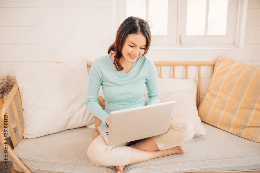 Young asian woman working on laptop at home. Young asian woman working on laptop at home.