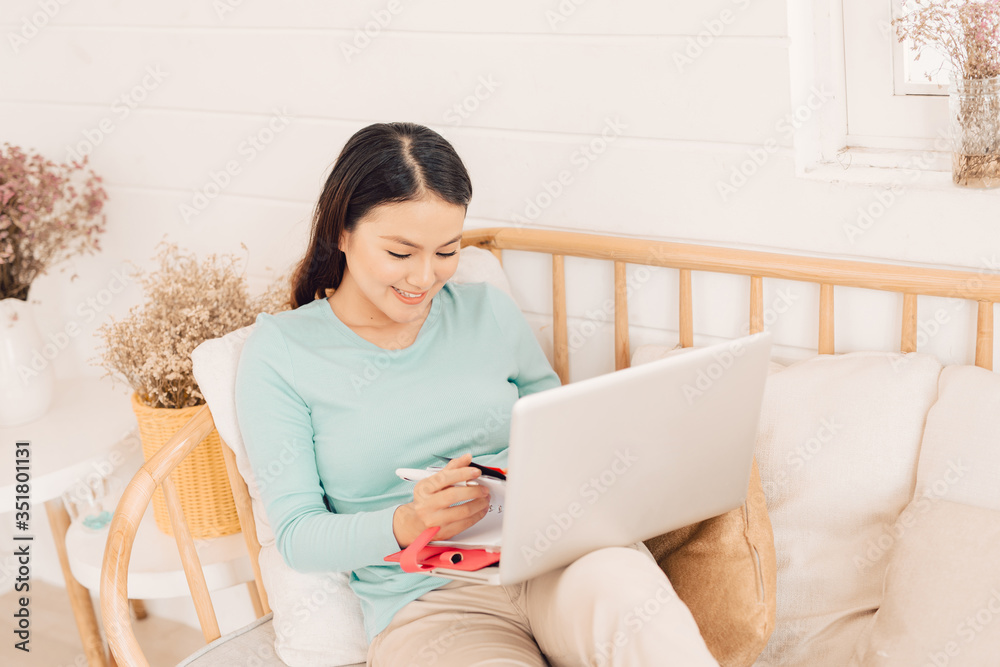Woman freelancer female hands with pen writing on notebook at home or office Woman freelancer female hands with pen writing on notebook at home or office