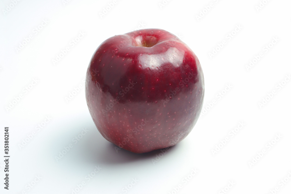One bright red apple on a white background