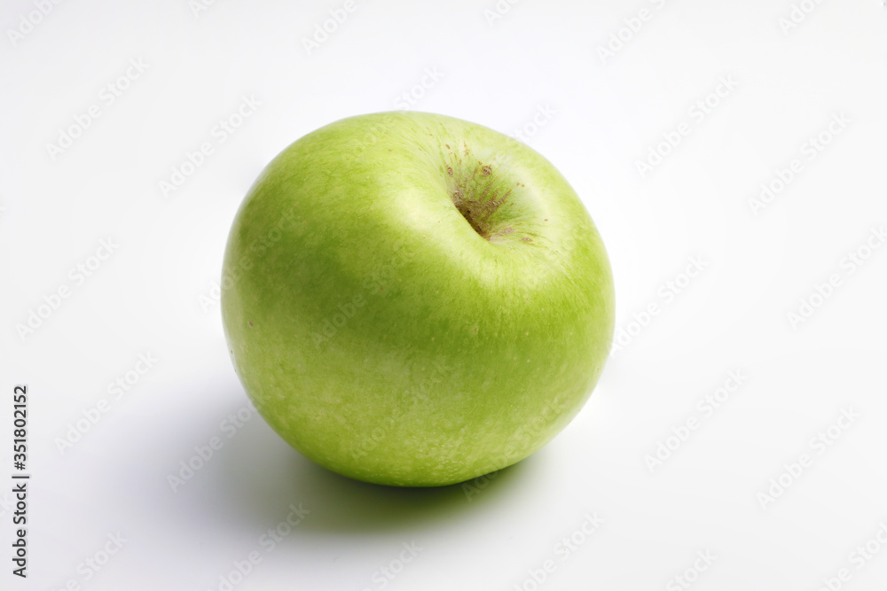 One fresh green apple on a white background One fresh green apple on a white background