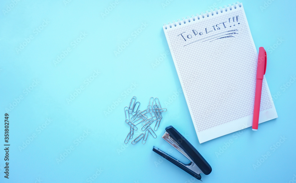 to-do list. Notepad with to-do list. pen Notepad for reports stapler paper clips photo