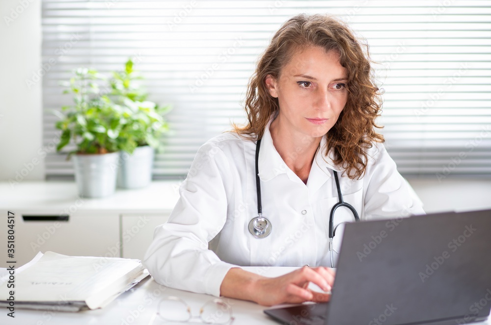 portrait of female doctor working on laptop telemedicine concept portrait of female doctor working on laptop telemedicine concept