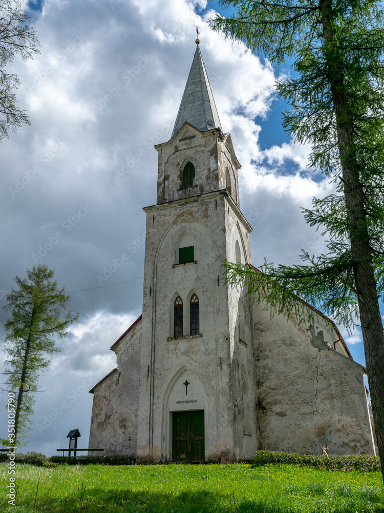white church on the hill, beautiful blue sky with white cumulus clouds, Trikata church, Latvia