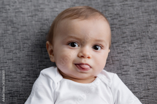 Portrait of cute baby sticking tongue