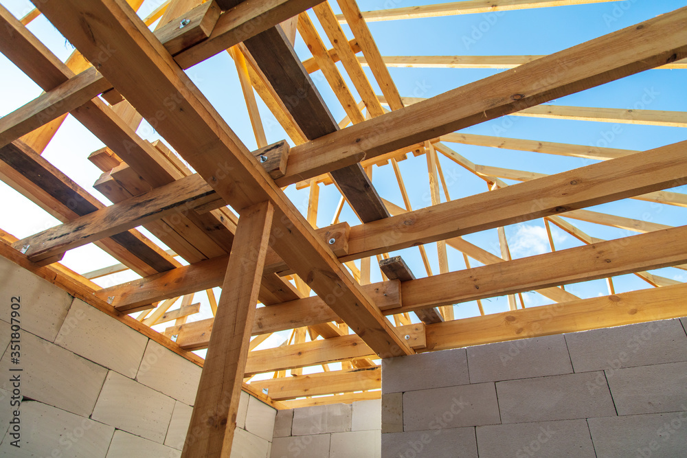 Fototapeta premium Wooden boards on the roof of the house against the sky.