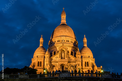Night view of the Basilica of the Sacred Heart of Paris, at the summit of the butte Montmartre, the highest point in Paris, France