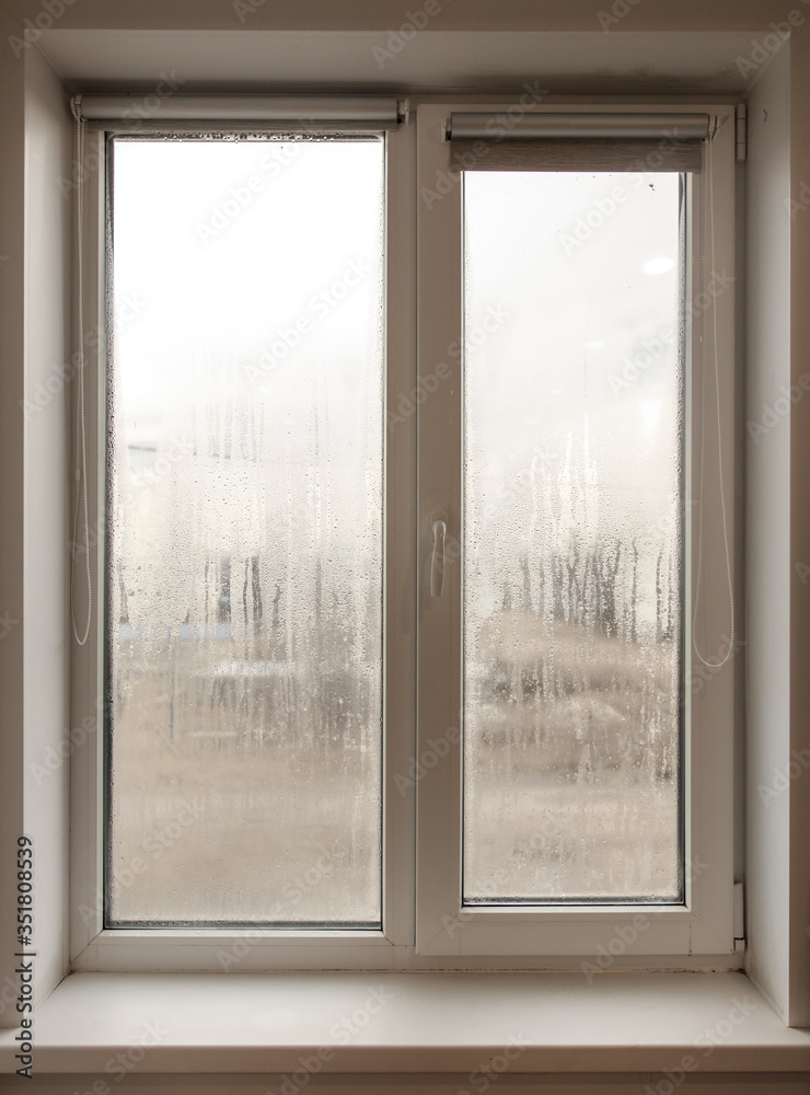Obraz premium A window with fogged windows in the room.