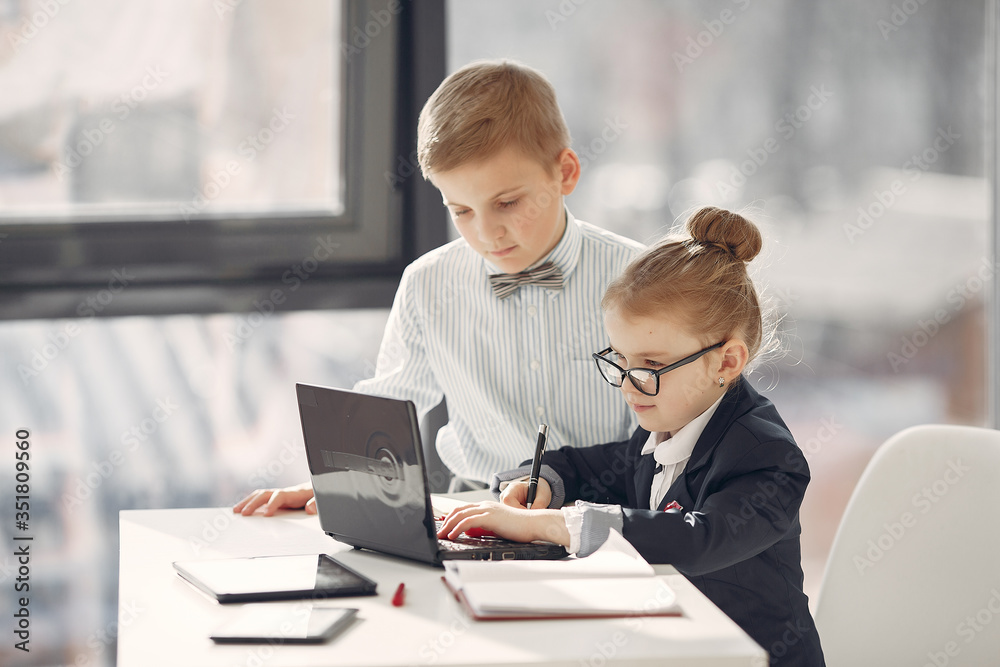 Business theme. Children in a business style. Kid with a laptop. Business theme. Children in a business style. Kid with a laptop.