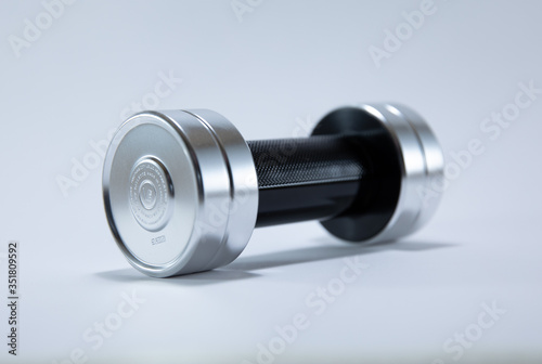 A perfume shape of dumbbell place in white background.