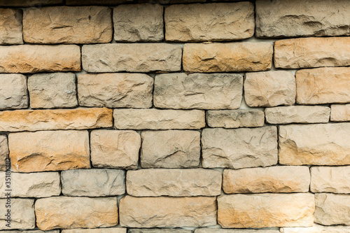The yellow stone interlocking brick wall texture