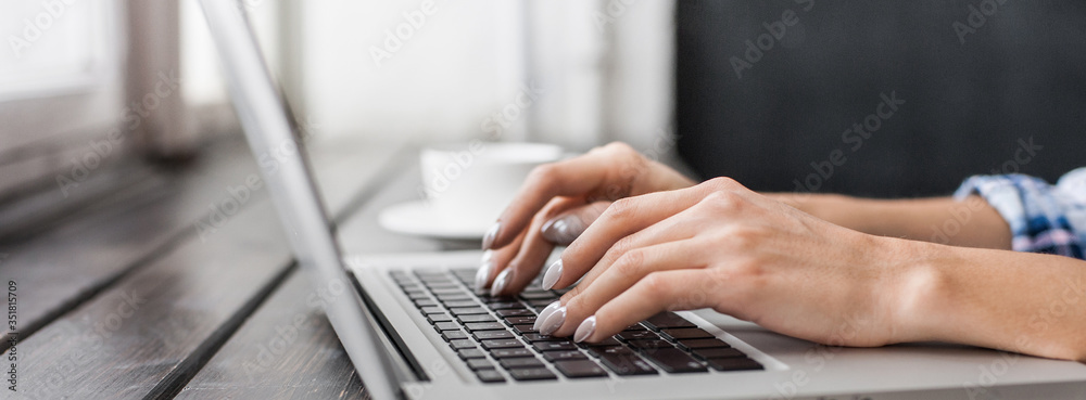 Young woman working at home or at cafe. Student girl using laptop computer, panoramic banner, Online shopping, work or study from home, freelance, online learning, distance education, studying concept