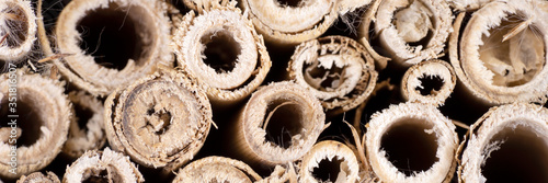 Panoramic image. Closeup wooden Insect hotel. Shelter for insects made in wood