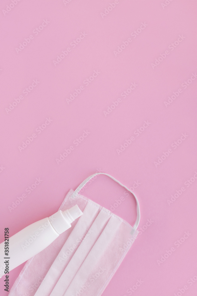 Antibacterial antiseptic spray and medical mask on pink background Antibacterial antiseptic spray and medical mask on pink background