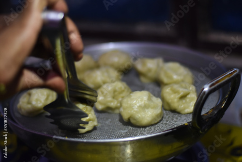 after corona virus lockdown avery restaurant and shops close so woman making momo at home, stay home stay safe, life during lockdown in India 