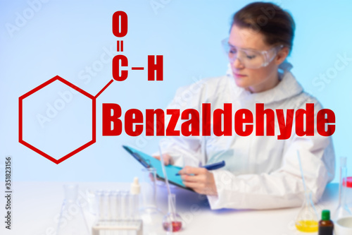Girl chemist in the laboratory against the background of the molecular formula and the inscription Benzaldehyde. Raw materials for the production of amphetamine. Types of solvents.