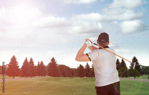 Senior man playing golf on course with green grass, back view. Space for design