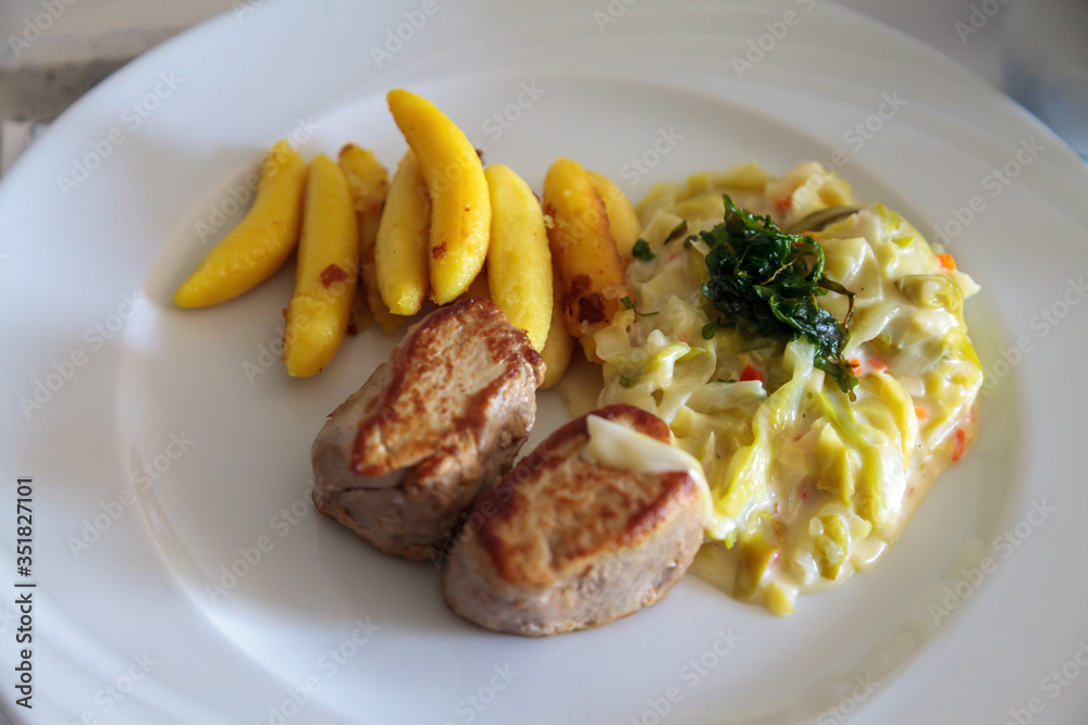 Close up of a healthy lunch with pork medallions Close up of a healthy lunch with pork medallions