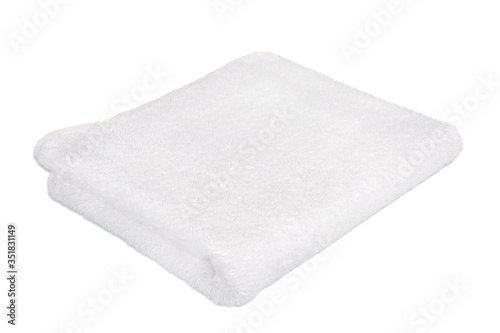A clean white Terry towel. Terry towel on a white background. Accessories for the bath. Cotton products. Towel made of bamboo fiber.