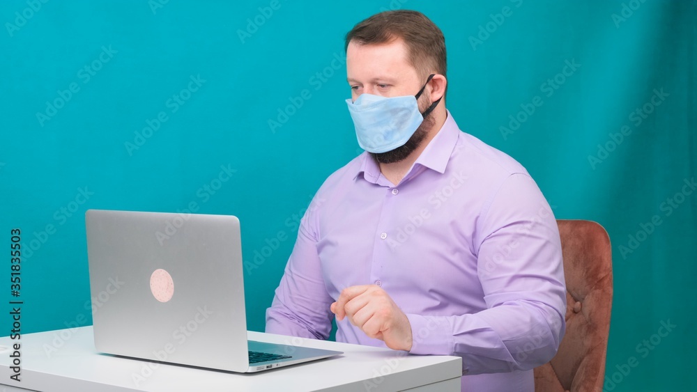 Caucasian adult bearded man works at home. Lifestyle concept photo with copy space. picture with a handsome guy who uses a protective mask. Caucasian adult bearded man works at home. Lifestyle concept photo with copy space. picture with a handsome guy who uses a protective mask.