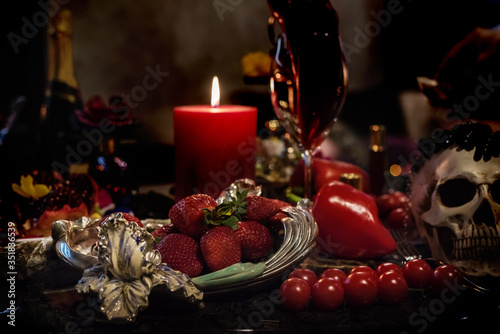 Exquisite table with strawberries and decorative items of luxury and sophistication. Dark glamorous photo.