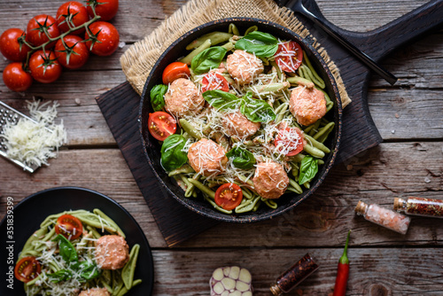 Delicious fresh pasta with meatballs, sauce, cherry tomatoes and basil