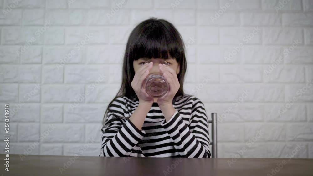 young girl drinking water, Thai kid drink in kitchen room, strong and good healthy young girl drinking water, Thai kid drink in kitchen room, strong and good healthy