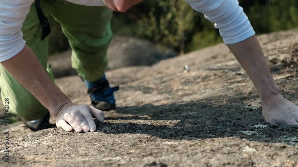 Close-up of the hands of a young athlete climbing on a rock. Close-up of the hands of a young athlete climbing on a rock.