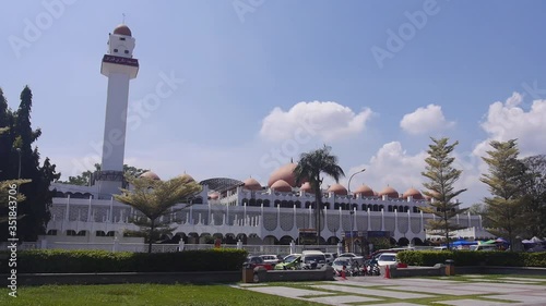 A big building of the mosque with cars in the distance - static photo