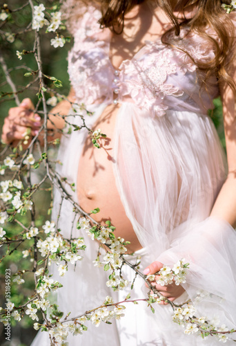 close-up of a pregnant woman's belly spring garden