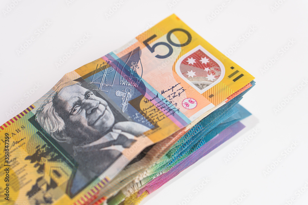 stack of australian dollar bills on white background